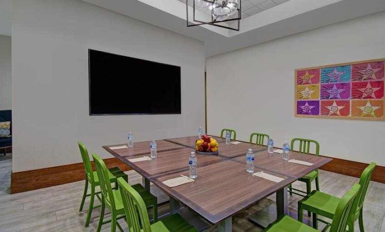 Large meeting room with tables and chairs at the Home2 Suites by Hilton Houston Medical Center.