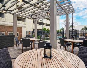 Outdoor patio with lounges perfect as workspace at the Home2 Suites by Hilton Houston Medical Center.