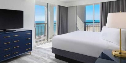 gorgeous king bedroom with sea views at Embassy Suites by Hilton Myrtle Beach Oceanfront Resort.