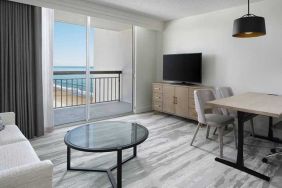 lounge area with work desk for all remote business needs at Embassy Suites by Hilton Myrtle Beach Oceanfront Resort.