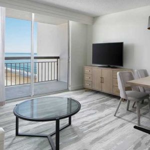 lounge area with work desk for all remote business needs at Embassy Suites by Hilton Myrtle Beach Oceanfront Resort.