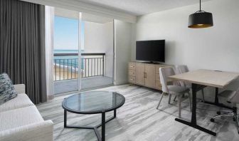 lounge area with work desk for all remote business needs at Embassy Suites by Hilton Myrtle Beach Oceanfront Resort.