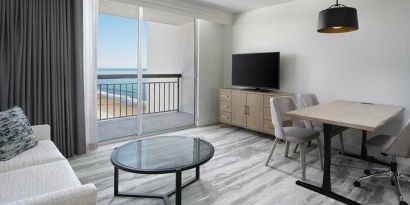 lounge area with work desk for all remote business needs at Embassy Suites by Hilton Myrtle Beach Oceanfront Resort.