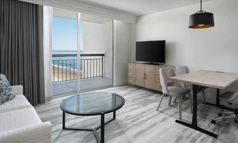 lounge area with work desk for all remote business needs at Embassy Suites by Hilton Myrtle Beach Oceanfront Resort.