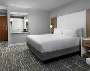 comfortable king bedroom with work desk at Hilton Myrtle Beach Resort.