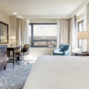 beautiful king room with work desk, TV, and natural light at Washington Hilton.