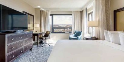 beautiful king room with work desk, TV, and natural light at Washington Hilton.