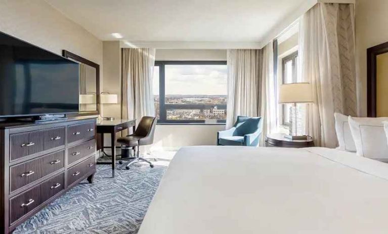 beautiful king room with work desk, TV, and natural light at Washington Hilton.