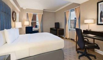 delux king room with TV, work desk, and natural light at Hilton Milwaukee City Center.