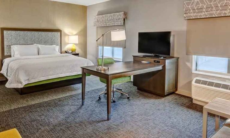 spacious delux king room with TV and business desk at Hampton Inn & Suites San Jose Airport.