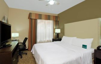 comfortable king delux room full furnished with TV and work desk at Homewood Suites by Hilton Houston-Woodlands.