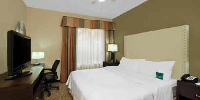 comfortable king delux room full furnished with TV and work desk at Homewood Suites by Hilton Houston-Woodlands.