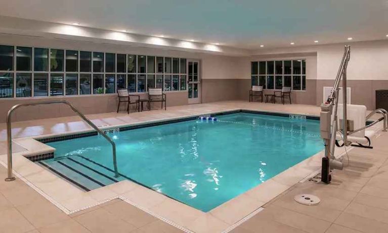 indoor pool with seating and accessible to otherwise-abled guests at Hilton Garden Inn Kansas City Airport.