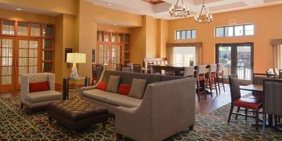 comfortable lobby lounge area ideal for coworking at Hampton Inn & Suites Pueblo-Southgate.