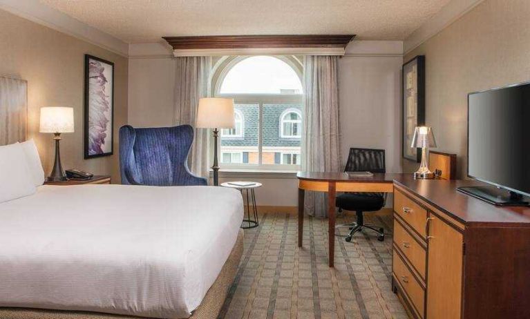 King guestroom with TV screen and desk at the Hilton Wilmington-Christiana.