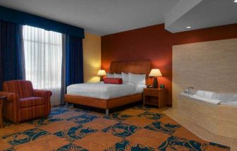 Comfortable king guestroom with window and whirlpool at the Hilton Garden Inn Fort Worth Medical Center.