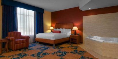 Comfortable king guestroom with window and whirlpool at the Hilton Garden Inn Fort Worth Medical Center.