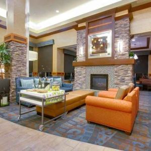 Stylish lobby workspace with fireplace and lounges at the Hilton Garden Inn Fort Worth Medical Center.