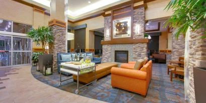 Stylish lobby workspace with fireplace and lounges at the Hilton Garden Inn Fort Worth Medical Center.