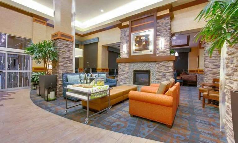 Stylish lobby workspace with fireplace and lounges at the Hilton Garden Inn Fort Worth Medical Center.