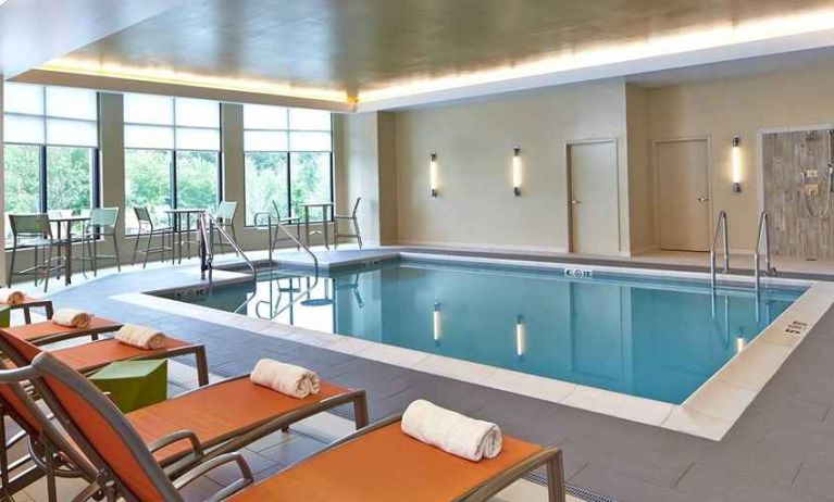 relaxing indoor pool with comfortable seating at Hilton Garden Inn Boston/Marlborough.