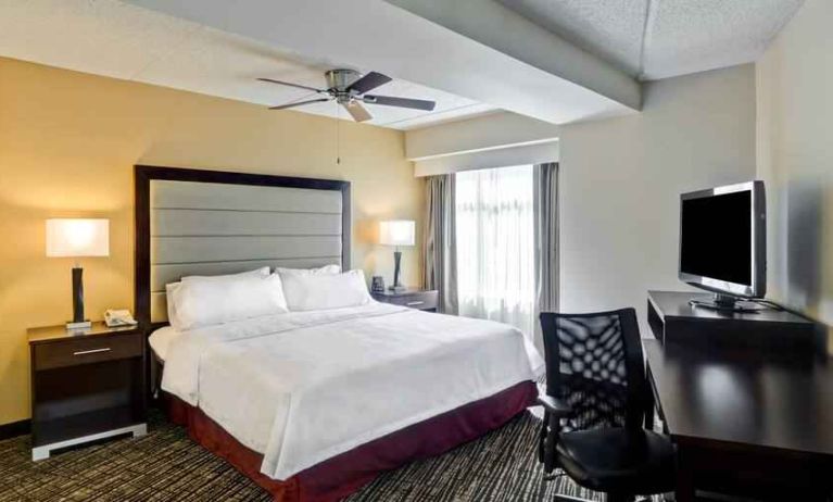 King bedroom with working station and TV screen at the Homewood Suites by Hilton Washington, D.C. Downtown.