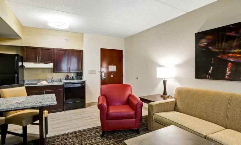 Spacious living room with desk in a hotel suite at the Homewood Suites by Hilton Washington, D.C. Downtown.