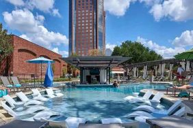 beautiful outdoor pool with sun beds and seating at Hilton Anatole.