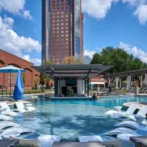 beautiful outdoor pool with sun beds and seating at Hilton Anatole.