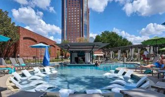 beautiful outdoor pool with sun beds and seating at Hilton Anatole.