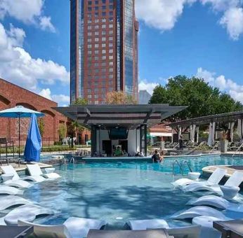 beautiful outdoor pool with sun beds and seating at Hilton Anatole.