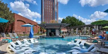 beautiful outdoor pool with sun beds and seating at Hilton Anatole.