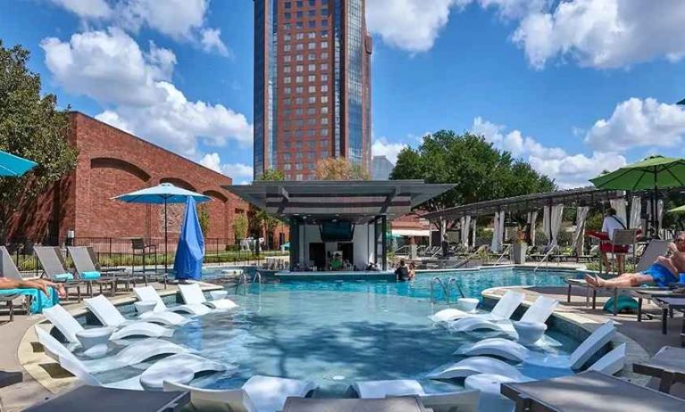 beautiful outdoor pool with sun beds and seating at Hilton Anatole.