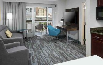 Living room with working station in a hotel suite at the Hampton Inn & Suites Memphis-Beale Street.