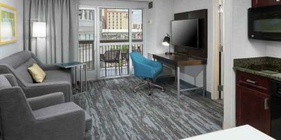 Living room with working station in a hotel suite at the Hampton Inn & Suites Memphis-Beale Street.