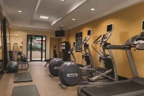 Fitness center with treadmills and mirrors at the Embassy Suites by Hilton Birmingham.