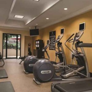 Fitness center with treadmills and mirrors at the Embassy Suites by Hilton Birmingham.