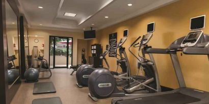 Fitness center with treadmills and mirrors at the Embassy Suites by Hilton Birmingham.