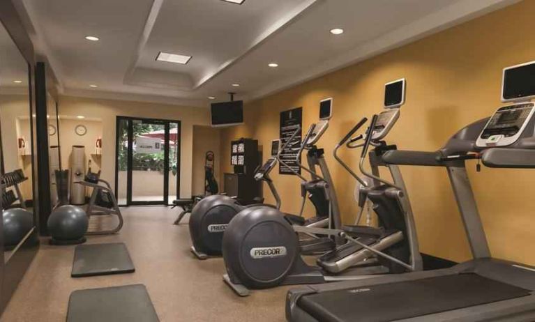 Fitness center with treadmills and mirrors at the Embassy Suites by Hilton Birmingham.