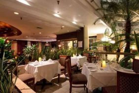 Elegant dining workspace with plants at the Embassy Suites by Hilton Birmingham.