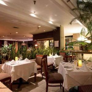 Elegant dining workspace with plants at the Embassy Suites by Hilton Birmingham.