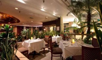 Elegant dining workspace with plants at the Embassy Suites by Hilton Birmingham.