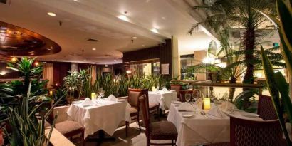 Elegant dining workspace with plants at the Embassy Suites by Hilton Birmingham.