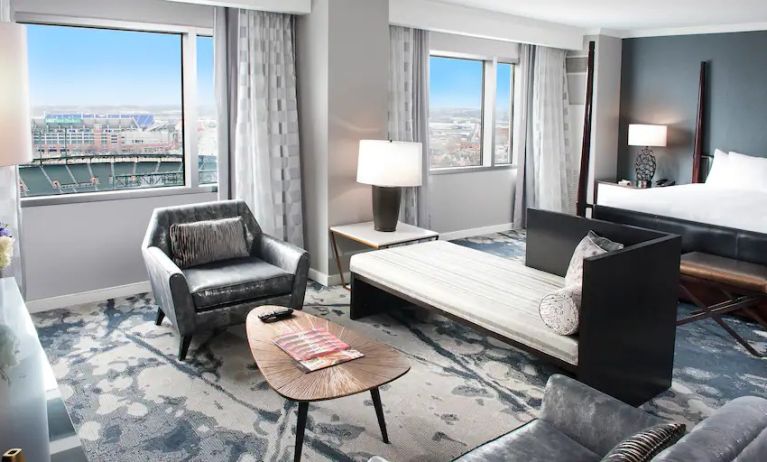 Beautiful and spacious presidential suite with table, sofa and windows at the Hilton Baltimore Inner Harbor.