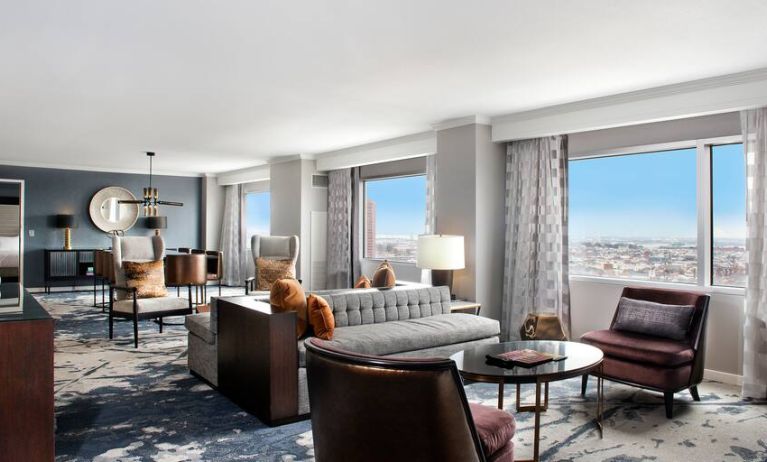 Beautiful and spacious presidential suite with table, sofa and windows at the Hilton Baltimore Inner Harbor.