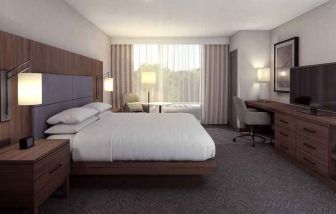 Spacious king bedroom with king size bed and sofa at the DoubleTree by Hilton Lafayette East.