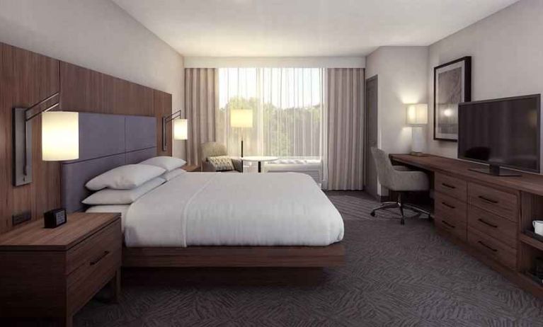 Spacious king bedroom with king size bed and sofa at the DoubleTree by Hilton Lafayette East.