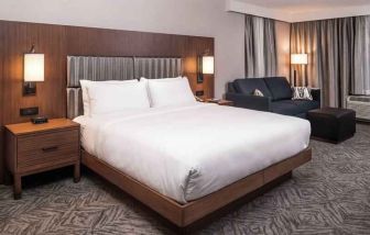 Spacious king bedroom with king size bed and sofa at the DoubleTree by Hilton Lafayette East.