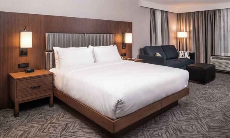 Spacious king bedroom with king size bed and sofa at the DoubleTree by Hilton Lafayette East.