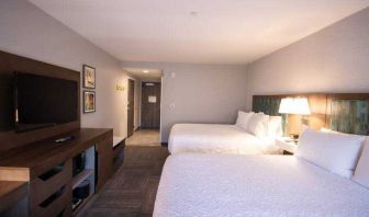 Double queen bedroom with TV screen at the Hampton Inn & Suites North Attleboro.